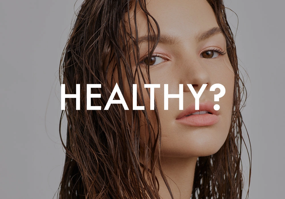 HEALTHY?: woman with wet hair tucked behind her ear