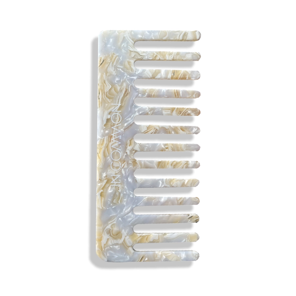 In Common detangling comb with gold flecks